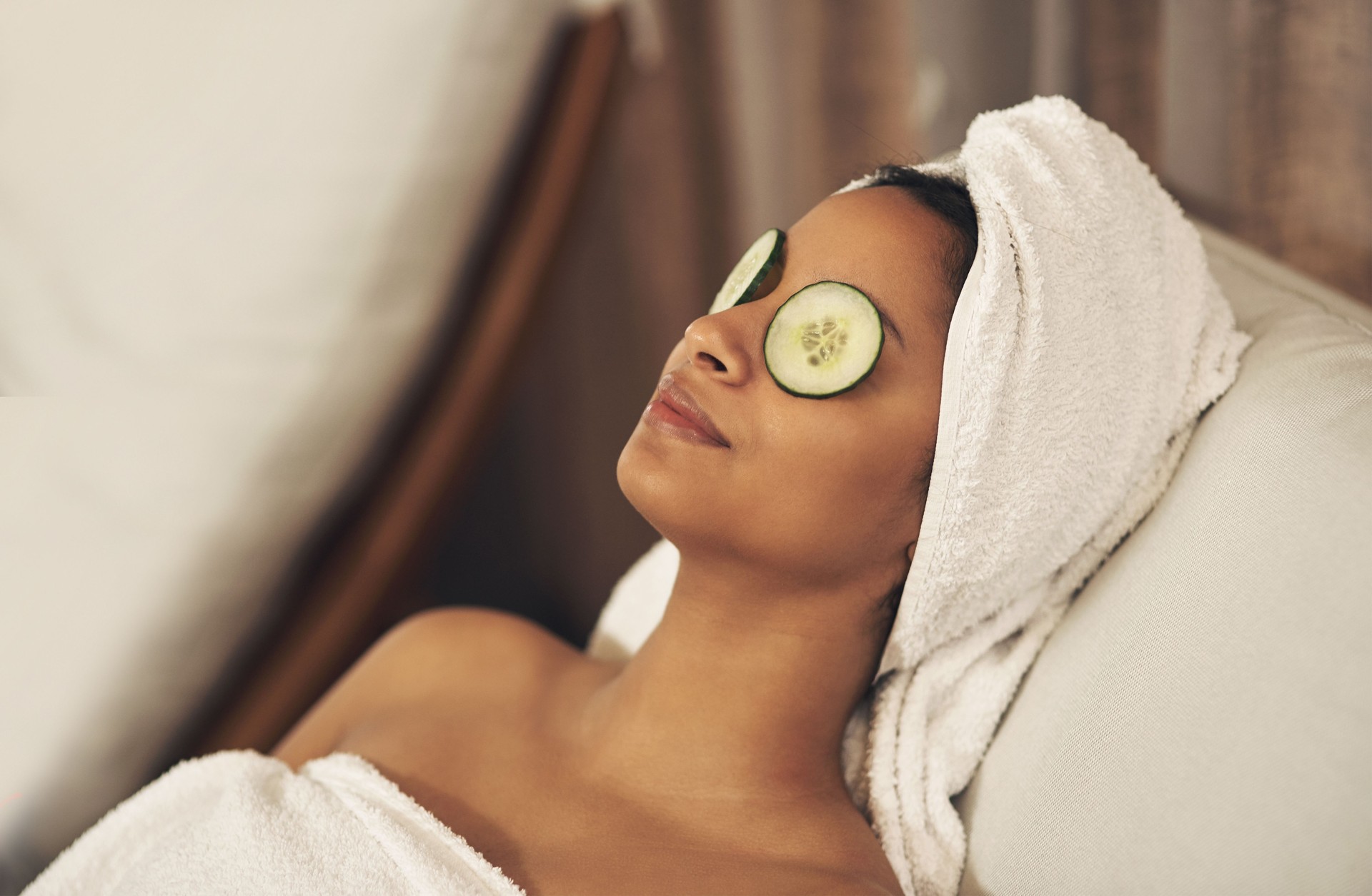 Shot of a woman relaxing in a spa with cucumber slices on her eyes
